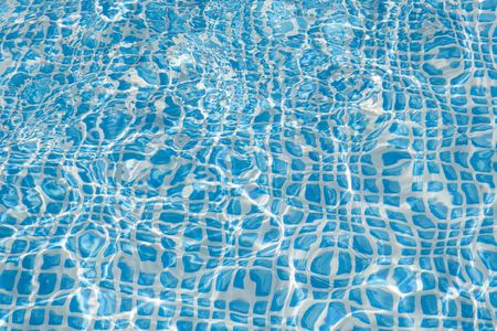 Wall of swimming pool with water of blue colorの写真素材