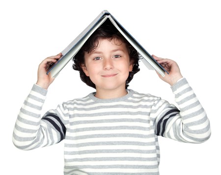Student child with a book over his head isolated over white background