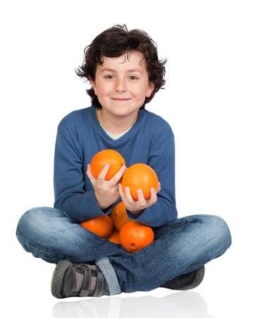 Funny child with many oranges isolated on white backgroundの写真素材