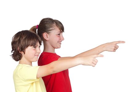 Adorable preteen girl and little boy finger pointing isolated on white backgroundの写真素材