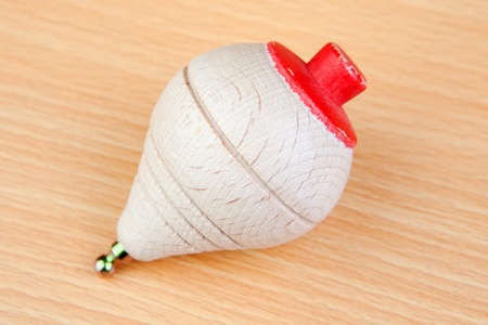 Wooden spinning top on a wooden background