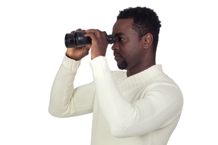Attractive african man looking through binoculars isolated on a over white backgroundの写真素材