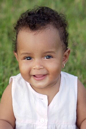 Adorable little african girl background with grassの写真素材