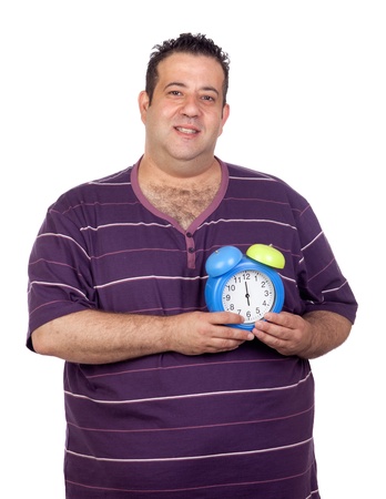 Fat man with a blue alarm clock isolated on white backgroundの写真素材