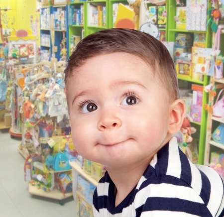Beautiful baby with nice eyes in the toy storeの写真素材