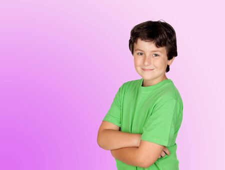 Funny child with green t-shirt isolated on pink and purple background