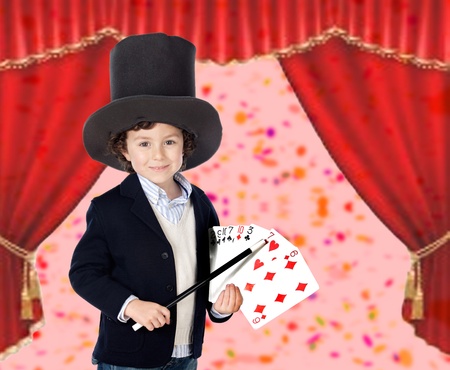 Young magician doing a card trick in a theaterの写真素材