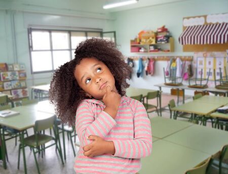 Pensive student african girl with beautiful hairstyle in the schoolの写真素材
