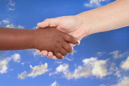 Handshake between an African-American and Caucasian isolated on white backgroundの写真素材