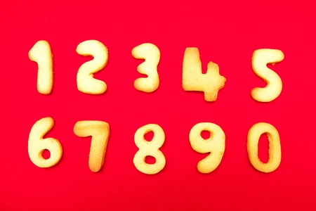 Appetizing cookies in shape numerals on the isolated red backgroundの写真素材