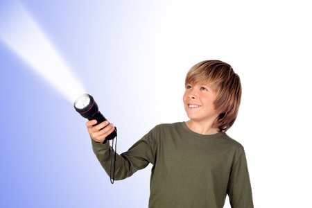 Child with a flashlight looking for something on blue backgroundの写真素材