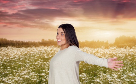 Happy woman in a beautiful floral landscape