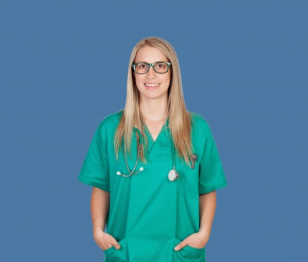 Atractive medical girl with glasses on a blue backgroundの写真素材