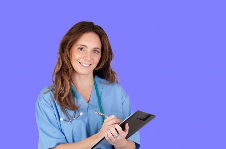 Atractive doctor girl with a clipboard on a blue backgroundの写真素材
