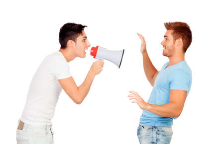 Young men screams to his friend through a megaphone isolated on a white backgroundの写真素材