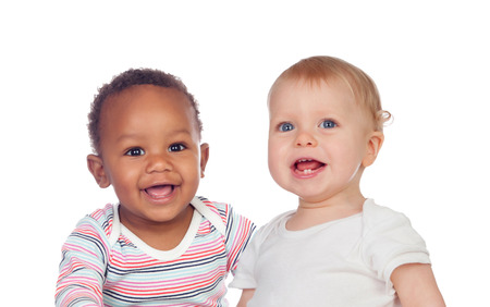 Couple of Babies African and Caucasian laughing on white backgroundの写真素材