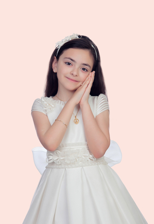 Adorable little girl dressed in communion isolated on white backgroundの写真素材