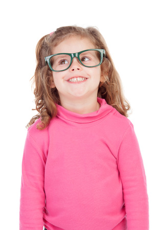 Little girl in pink with glasses looking up isolated on a white backgroundの写真素材