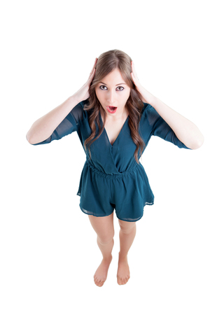Surprised girl seen from above isolated on a white backgroundの写真素材