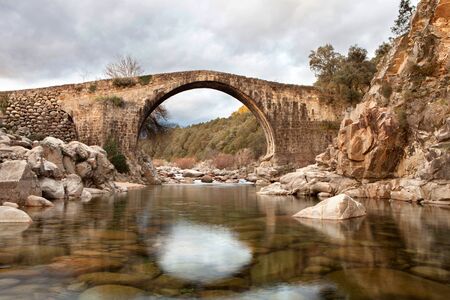 Beautiful bridge with a clear river in mountain of Spainの写真素材