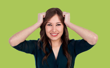 Worried young cool woman on a green background