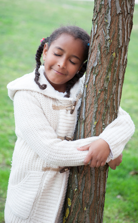 Pretty african girl with winter clothes in the parkの写真素材