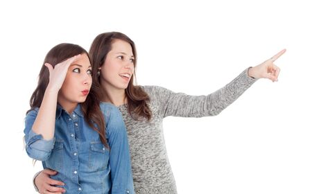 Two best friends looking at side isolated on a white backgroundの写真素材