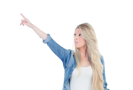 Blonde girl indicating something isolated on a white backgroundの写真素材