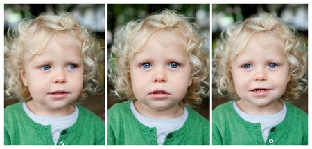 Little baby boy with curl hair and blue eyes smilingの写真素材