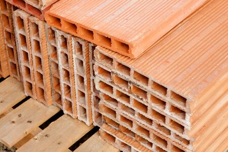 Red bricks stacked. Material prepared for the construction