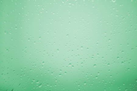 Wet glass with drops of rain fall on the streetの写真素材