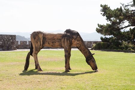 Sculpture of a wooden horse near the castle of Bayona in Spainの写真素材