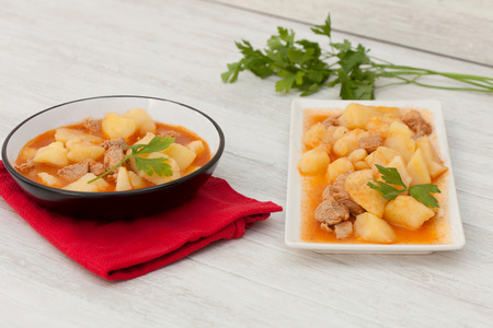 Delicious dishs of cooked potatoes with meat on gray wooden backgroundの写真素材