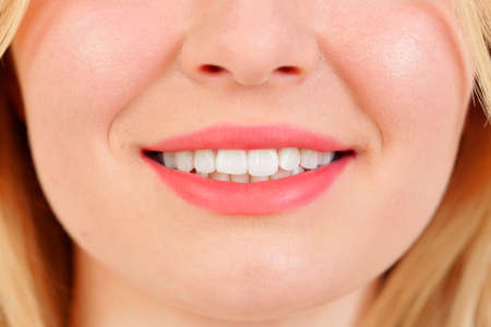 Beautiful smile of blonde girl with white teeths