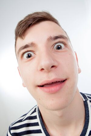 Funny guy grimacing with her face isolated on white background