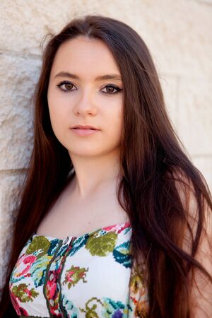 Spanish brunette girl with long hair on the streetの写真素材