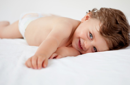 Baby with one years old getting out of bed doing gesturesの写真素材