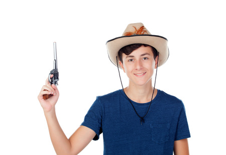 Teenager boy with a cowboy hat and a gun isolated on white backgroundの写真素材