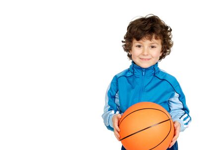 Smiling boy with six years old with a basket ball looking at cameraの写真素材