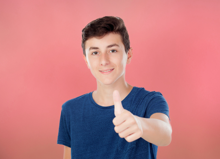 Brown young caucasian boy on red backgroundの写真素材