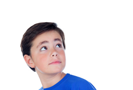 Funny child with ten years old and blue t-shirt looking up isolated on a white background