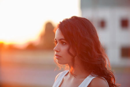 Beauty Sunshine Girl Portrait. Sunny Summer Day under the Hot Sun. Happy Woman Smiling and looking at camera.の写真素材