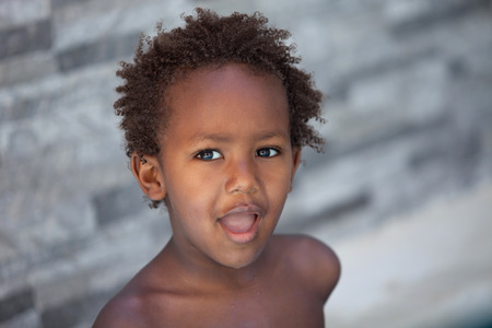 African little kid three years without a shirt on a summer day