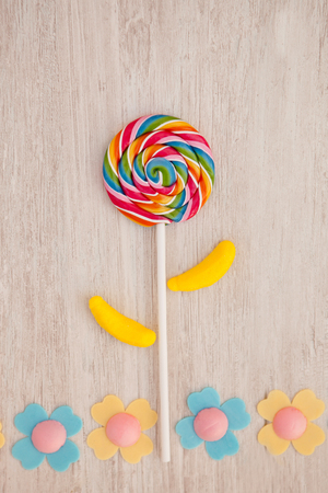 Beautiful landscape formed with a lollipop and candies resembling a flowerの写真素材