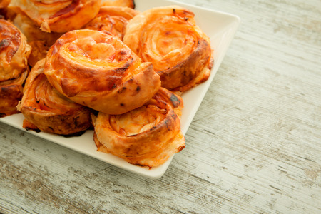 Savory puff pastries spiral shaped filled cheeseの写真素材