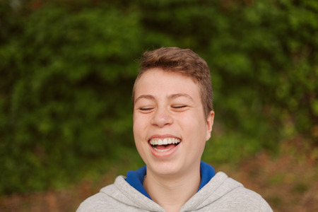 Cool teenager with fifty years old outside laughingの写真素材