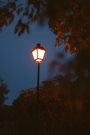 Lighted lantern on a dark blue sky at the beginning of twilight