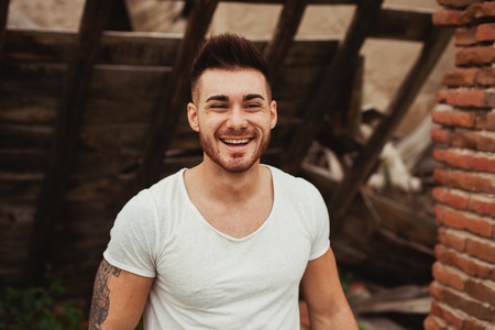Attractive guy with white t-shirt in a old house. Image for adの写真素材
