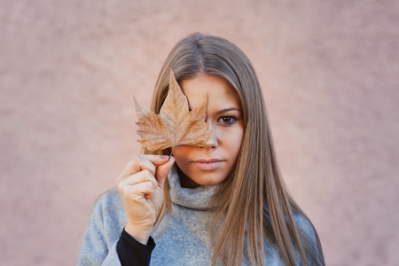 Pretty Girl with tree Leaf. Autumn Conceptの写真素材