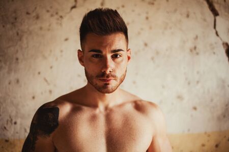 Attractive guy with the torso discovered showing his musclesの写真素材